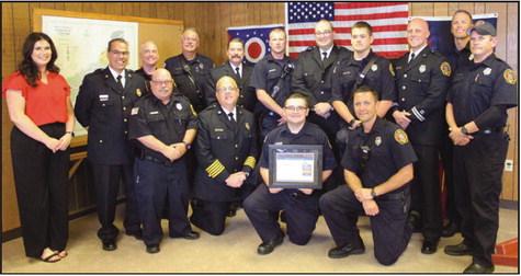 Firefighting team members display the department’s new American Heart Association award.