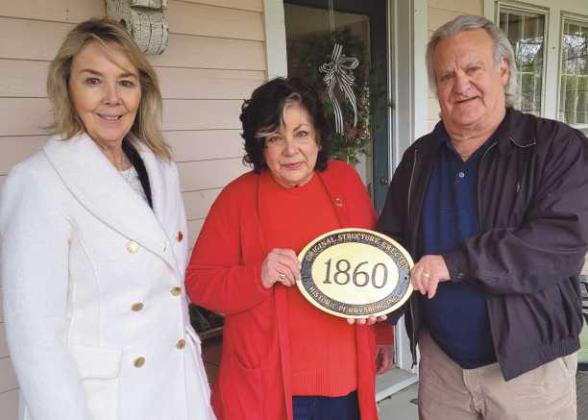 Diane Rogers, of the Guest House, 120/122 West Louisiana Avenue, recently received a historic marker from Historic Perrysburg Inc. Pictured are, from left: Joy Studer, Ms. Rogers and Dave Kleeberger. The home was built in 1860.