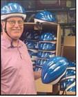 Charlie Gries with the donated helmets.