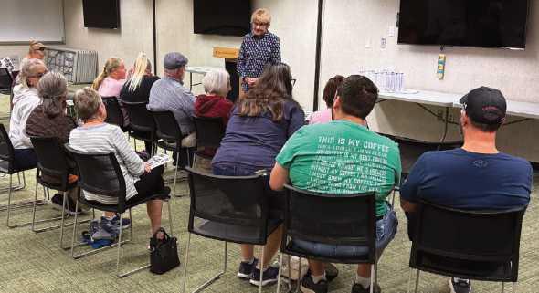 Director of the annual Historic Perrysburg Inc. Architectural Scavenger Hunt, Kitty Gibson, addresses the participants’ questions about some of the clues.