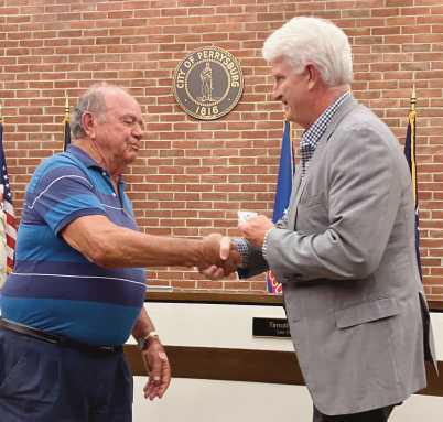 Mayor Mackin (right) shakes hands with Bob Warnimont (left) in recognition of his service to the Fort Meigs Cemetery Board.