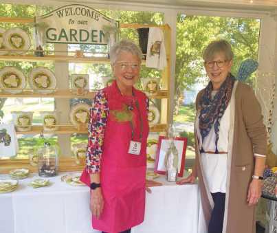 Country Garden Club members Kathy Attwood, at left, and Colleen McGoldrick in front of the club booth at the 2022 trunk show. Ms. McGoldrick is a co-chair of the upcoming show.