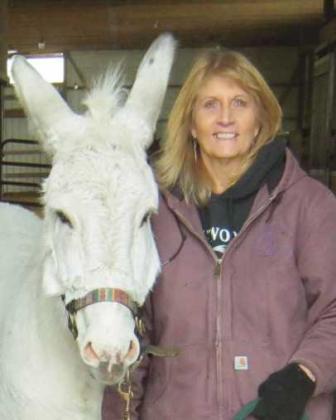 Nancy Swigart, founder and director of the Healing Barn, with barn mascot Jack the donkey.