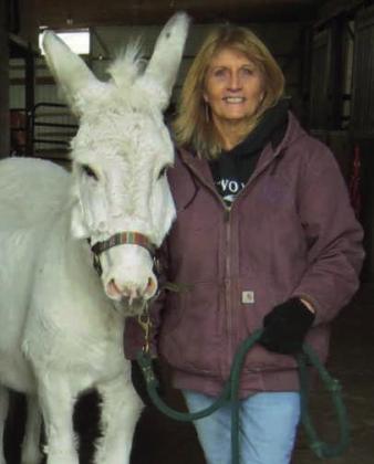 Healing Barn Founder and Director Nancy Swigart, with barn mascot Jack the donkey, who turned 34 this year.