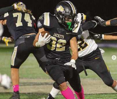 Runningback Joseph Seney scampers past the Wildcats. The Jackets wore pink socks for Breast Cancer Awareness month.