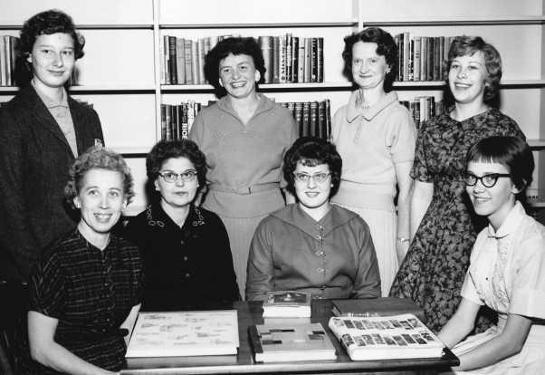 Way Public Library staff, approximately 1958, standing, from left: Judy Cable, Martha Hoffmann, Marguerite Heiderhorst and Patricia Roberts. Seated from left: Norma Anning, Phyllis Robison, Kay Cleary and Nancy English.