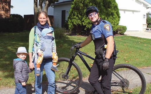 During a bicycle patrol through the neighborhoods behind Kohls and Lowe’s, Perrysburg Township Officer Ross Wheatley stops to chat with a family who recently relocated to the area from Germany.