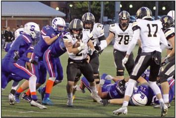 Quarterback T.J. Takats breaks through a hole up the center.