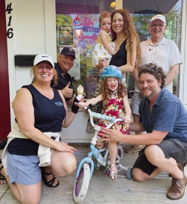 From left, back row: Officer Greg Cole, mom Emily Schooler holding Josie and Mayor Mark Weber. Front row: O-Deer Diner owner Alexa Farley, Shiloh Schooler and her dad Chris Schooler.