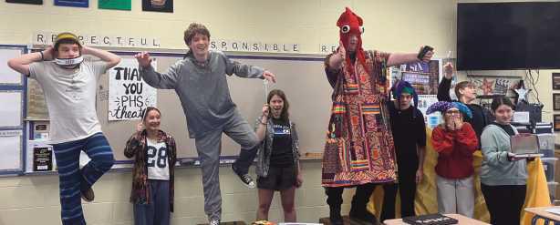 Students demonstrate the space scene from their play.