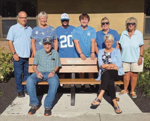 The McMorgan family at Municipal Park, pictured with the bench they donated to the city in honor of Jim.