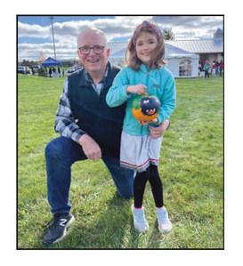 Above: Lena Coulson (right), pictured with her grandfather and Perrysburg Rotarian Mark Weber (left), displays her painted pumpkin from last year’s event. Below: BGSU mascot Freida Falcon (along with Freddie) will once again participate in the pumpkin races.
