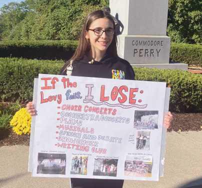 Rally organizer Delilah with her sign