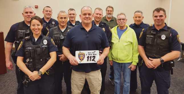 From left: Patrol Officer Chris Klewer, Patrol Officer Alicia Cryan, Patrol Officer Nick Owens, Sargeant Scott Mezinger, Lieutenant Dave Molter, retiring Deputy Chief Dave Nixon, Chief Matt Gazarek, Administrator Jon Eckel, Trustee Gary Britten, Lieutenant Jason Gladney and Patrol Officer Ryan Welch.