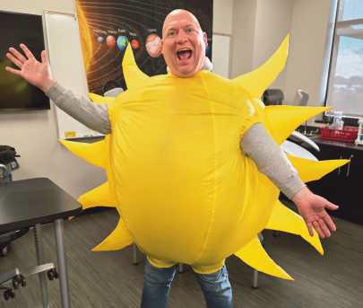 Jason Jordan assisting in a science lesson at HPI by dressing as the sun.