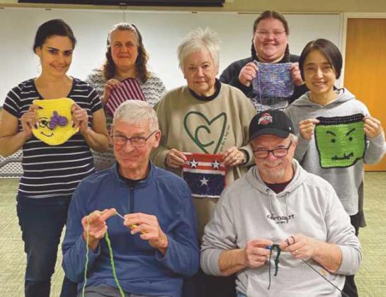 Participants in the America 250 Ohio: knit and crochet class show their submissions for the Framework of America Community Fiber Arts Mural.