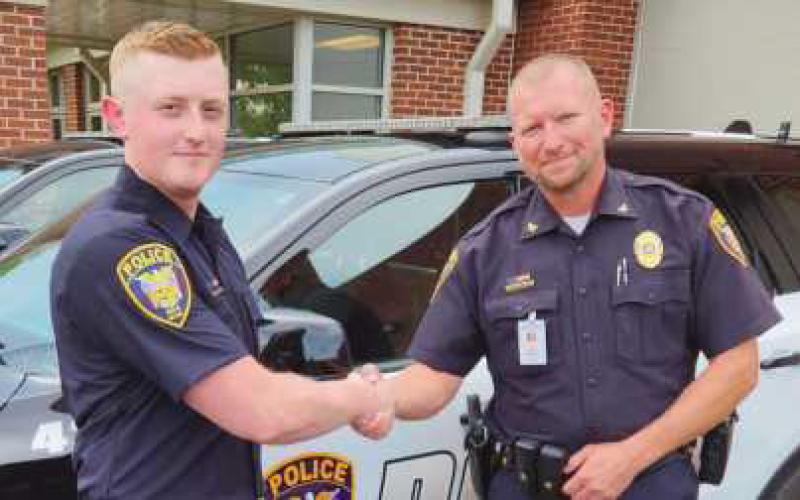From left: newly-hired Patrol Officer David Moore with Police Chief Matt Gazarek