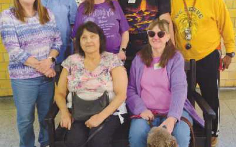 Club members on the TREX bench they earned by recycling 1,000 pounds of pastic. The bench will be installed for public use in Perrysburg.