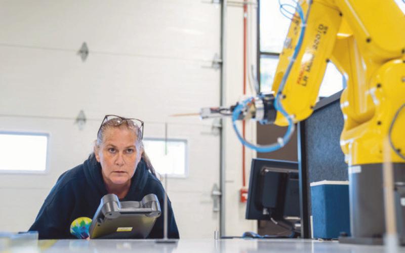 Owens student, Sandra Glosch, uses one of the robots at the college’s department of skilled trades in the Dana Center.