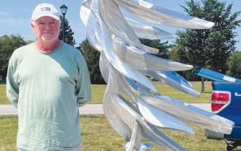 Artist Michael Young with his sculpture Quantum Flock.