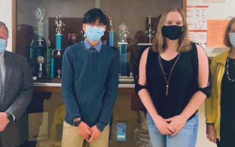 PHS Class of 2021 valedictorian and National Merit Commended Scholar Evan Leong, and salutatorian and National Merit Finalist Hope Neal with school board members Eric Benington and Sue Larimer.