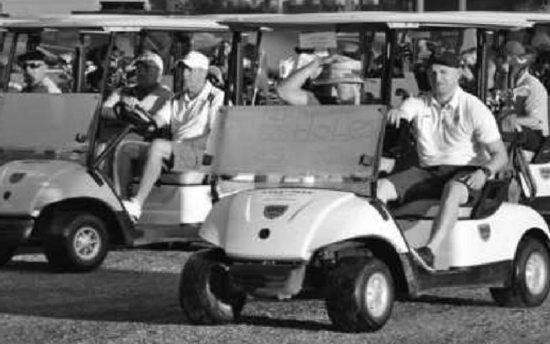 Golfers prepare for a fun day on the course in this look back at a past Putts For Mutts fund-raiser.