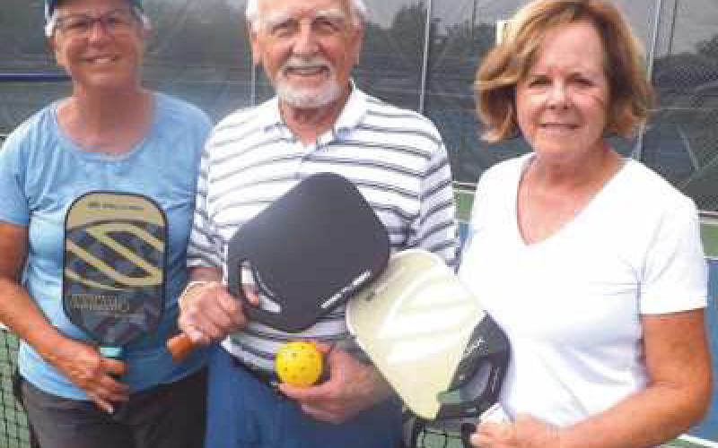 Pickleball partners, from left, Deb Sell, Paul Smithers and Jody Sullivan at Municipal Park court.