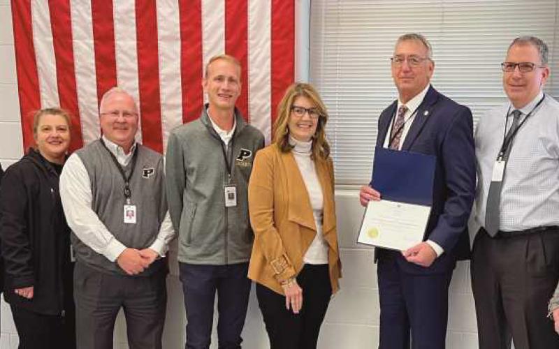 Lori Brodie, center, with the Perrysburg School Board presenting the school’s treasurer with the Auditor of State award.