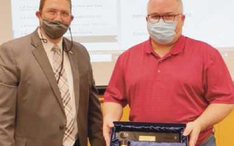 Superintendent Ed Ewers, left, presents board president Ken Sutter of Rossford with a token of appreciation for his two-year service as president.