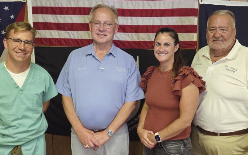 Perrysburg Township elected officials memorialize the last regular meeting of the board of trustees in the 1960s era building on Lime City Road. Future meetings will be held in the newly-constructed administration building located immediately south of the old building. From left: Trustee Jeffrey Moore, Trustee Bob Mack, Fiscal Officer Gretchen Welch and Trustee Joe Schaller.