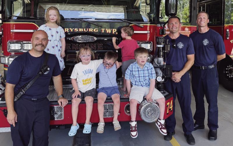 The Perrysburg Township Firefighters donated $1,275 to Down Syndrome Association of Greater Toledo. Mike Thompson, Levi Kuebler and Captain Chad Hartman are pictured above with children from the Down Syndrome Association of Greater Toledo.
