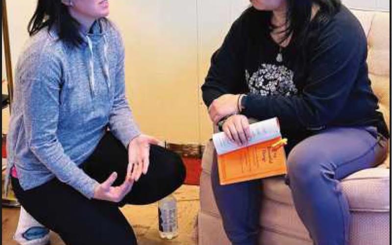 Perrysburg resident Marissa Rex, left, and Gloria Wang rehearse for “Tiny Beautiful Things.”