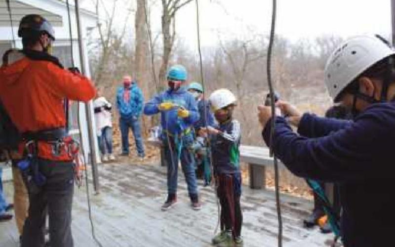 Top photo: Mr. Worscham helps Nolan Diefenthaler assume the correct position for safe rappelling. Lower left: Mr. Worscham and Mr. Spicer check the ropes. Lower right: Mr. Worscham instructs participants on how the ropes work during rappel.