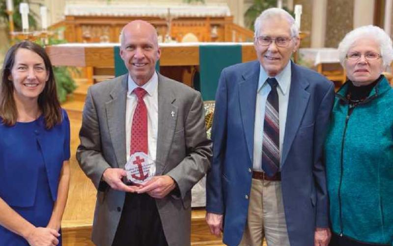 Deacon Dan Brahier, second from left, receives his award, accompanied by his wife, Anne, and his father Frank Brahier and Frank’s wife, Linda.