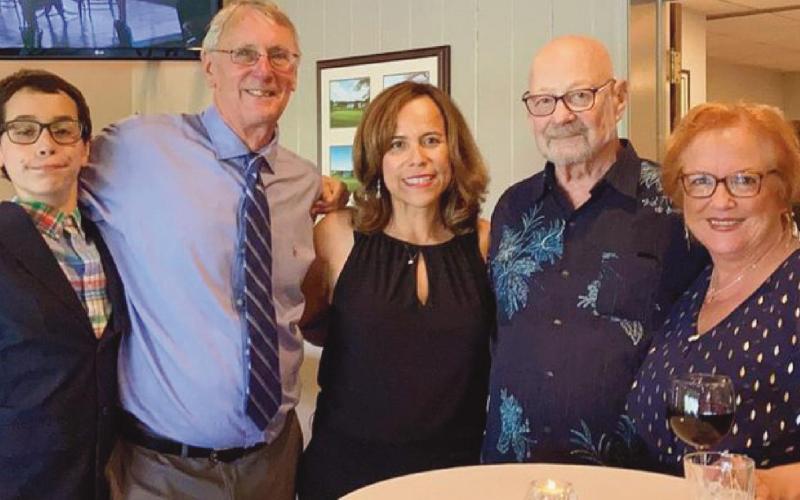 With Lorena Gloden, center, last July at the chapter meeting where she was named president of Rotary Club of Perrysburg, are, from left, her son Sebastian, her husband Dan, and her host parents Duane and Debbie Chappuies.