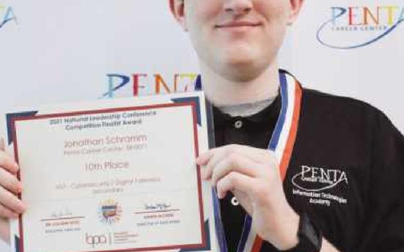 Jonathan Schramm with the certificate and medal he recently won at a cybersecurity/digital forensics competition.