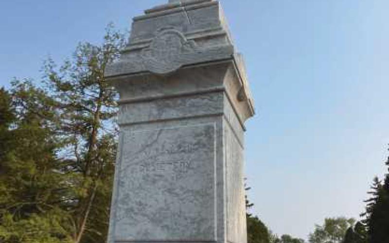 Volunteers help shine up St. Rose cemetery monument