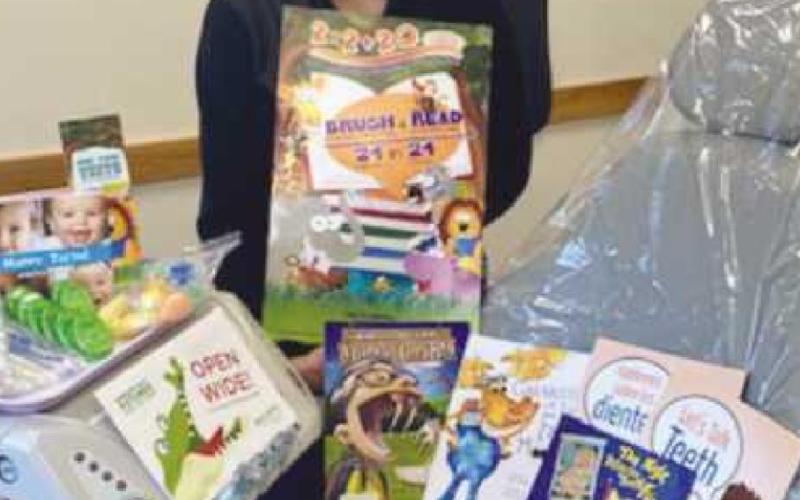 At right, dental assistant Merrilee Ewing-Beckley appears with a few of the donated items, which will be used to educate and improve dental care.
