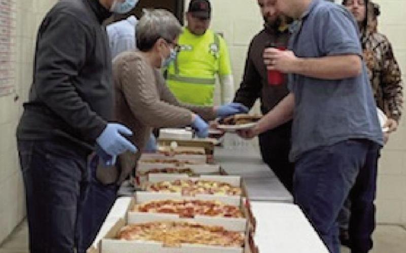 Members of the City of Perrysburg’s public service crew enjoy the gift of pizza from Julie Spann Johnson of State Farm Insurance.
