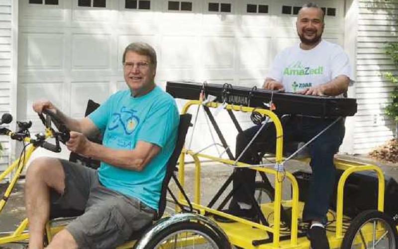 Omaldo Perez, right, will play live music during the June 7 cycle through Perrysburg. Here, Charlie Gries chauffeurs him around, but on June 7, his driver will be Jared Parseghian, owner of ParBike.