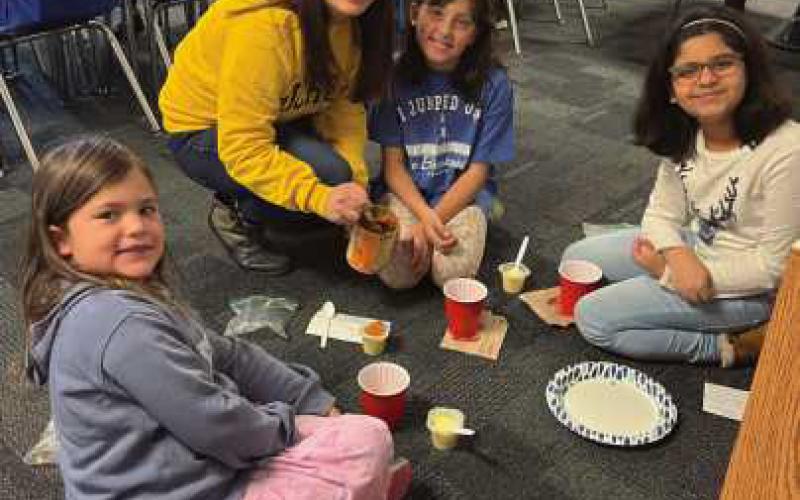 Elementary students prepare pumpkin pie in a cup