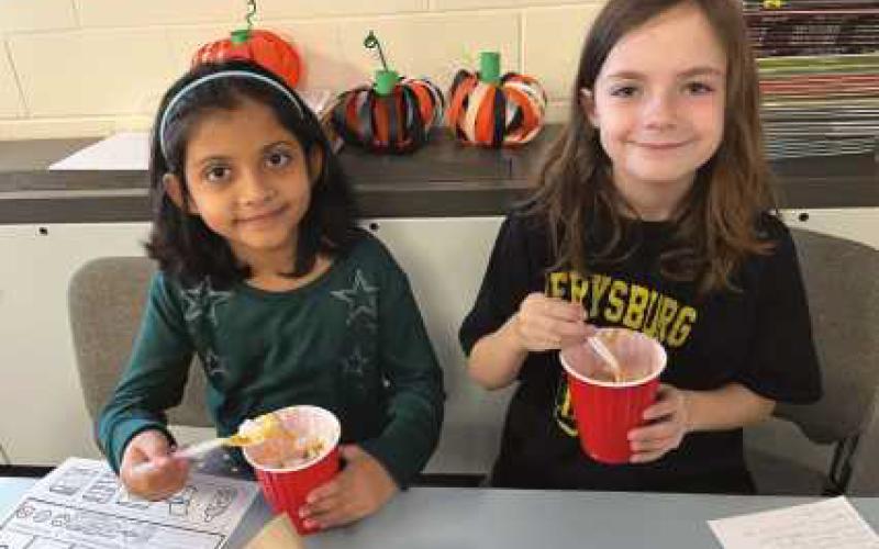 Elementary students prepare pumpkin pie in a cup