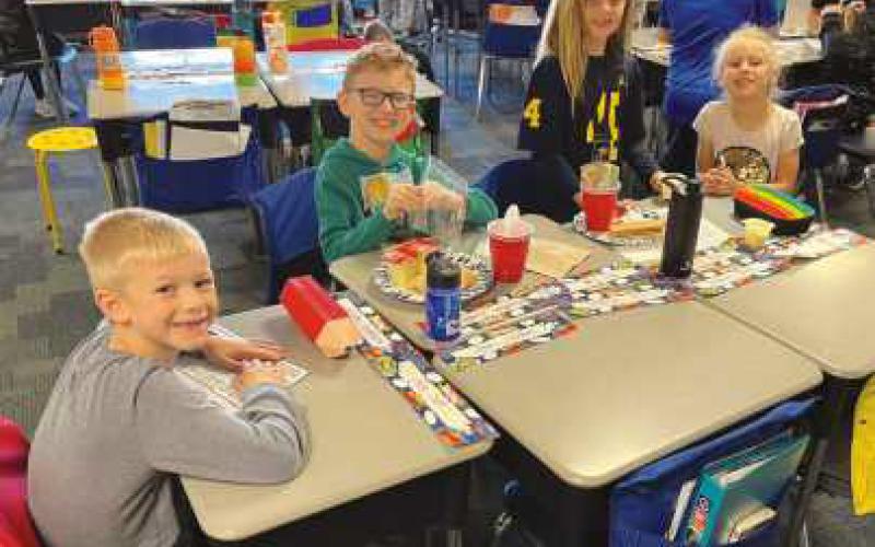 Elementary students prepare pumpkin pie in a cup