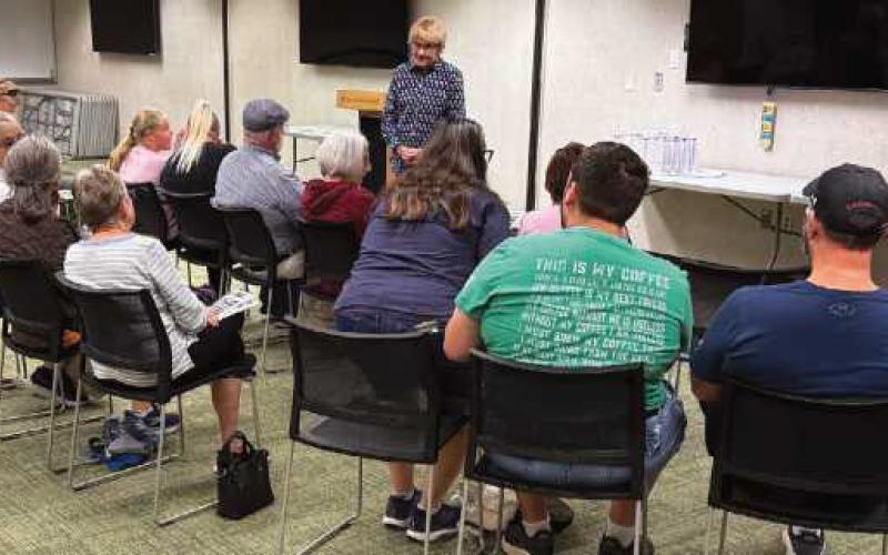 Director of the annual Historic Perrysburg Inc. Architectural Scavenger Hunt, Kitty Gibson, addresses the participants’ questions about some of the clues.