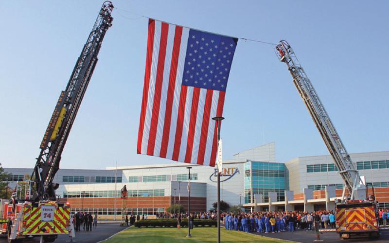 Perrysburg Township and Pemberville fire departments raise the American flag prior to the ceremony at Penta Career Center.
