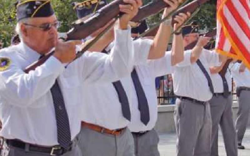 The Wood County Honors Detail fires a 21-gun salute.
