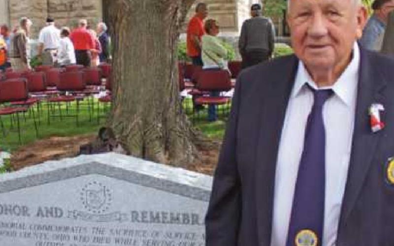 Former Commissioner Jim Carter, a veteran, views the Honor and Remembrance memorial.