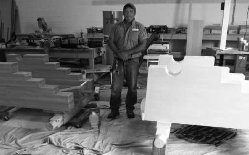 City carpenter Craig Hufford stands between the two carriages that will hold the cannons.