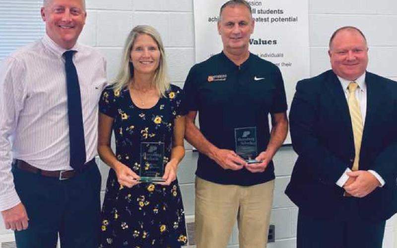 Two school staff members were honored upon their retirements by the school board. They are Lisa Wagner, PHS science teacher from 1991 to 2022, and Dave Boyce, PHS assistant principal, teacher and coach from 2000 to 2022. With them are PHS principal Aaron Cookson, far left, and board president Eric Benington, far right. Not pictured is Rebecca McKinney, bus driver and transportation department staff from 1993 to 2022.