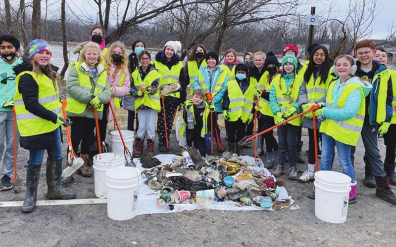Members of the Hull Prairie Intermediate Environmental Club proudly show off the 42 pounds of trash collected near the Maumee River in Perrysburg.
